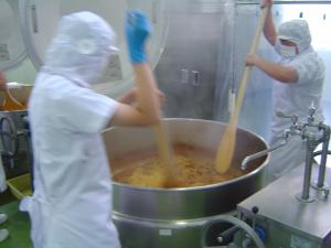 中学生がパスタを和える