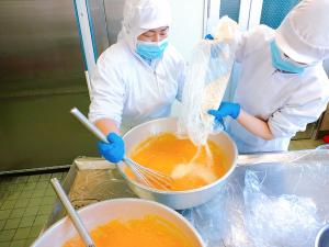 卵にパン粉と粉チーズを入れて混ぜています